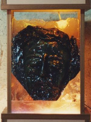 Sculpture du visage du Christ marqué par la souffrance mais baignant dans la lumière de Dieu